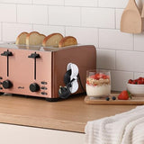 Cable organiser holding the cord of a pink toaster on a kitchen counter
