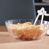 White finger chopsticks resting in a glass bowl of crisps