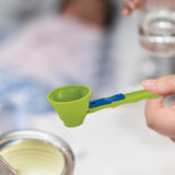 Measuring scoop being used to fill a jar in a kitchen