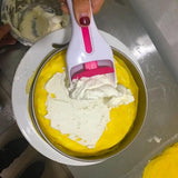 Scooping pale cake batter into a round baking tin