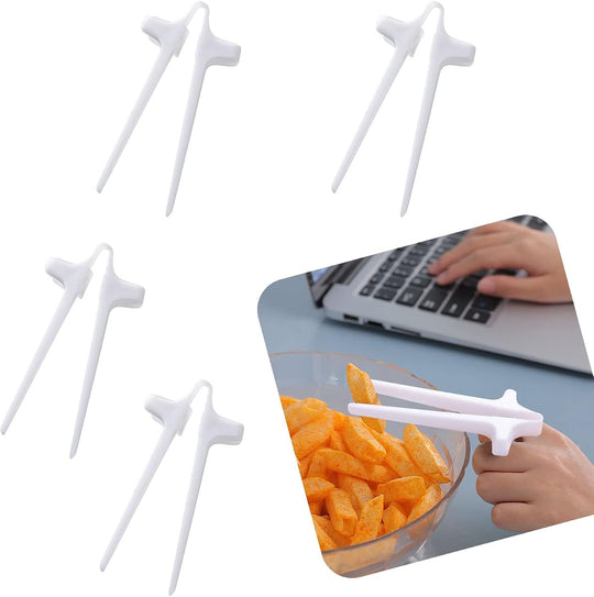 White finger chopsticks beside a bowl of crisps being eaten at a laptop