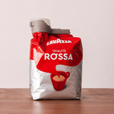 Sealing clip fitted to a coffee bag standing on a wooden table
