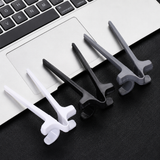 White, black and grey finger chopsticks laid out on a laptop