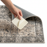 Sticking a white non-slip pad under the corner of a patterned rug
