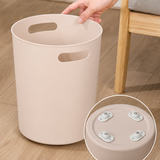 Caster wheels fitted under a pink bin, rolling on a wooden floor