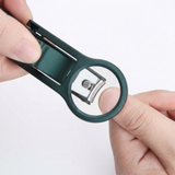 Hands holding the nail clipper with the magnifying lens folded over the blade